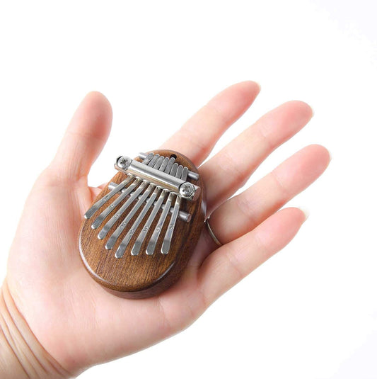 Piano de pulgar Mini Kalimba de madera maciza de alta calidad. instrumento musical portátil. 8 teclas Mini Kalimba dedo pulgar piano marimba musical buen accesorio colgante regalo